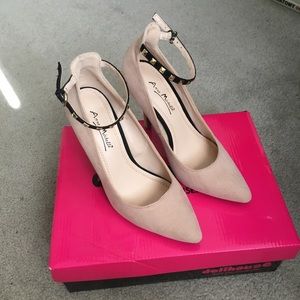 Nude with studded black strap heels